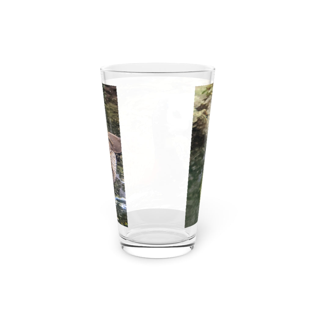 A clear 16oz Duck Pint Glass showcasing a custom printed design, perfect for beverages.