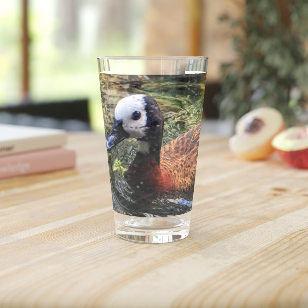 A clear 16oz Duck Pint Glass showcasing a custom printed design, perfect for beverages.