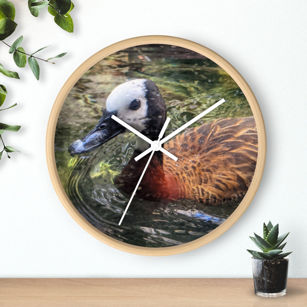 A charming Duck Wall Clock featuring a wooden frame and a plexiglass face, perfect for indoor decor.