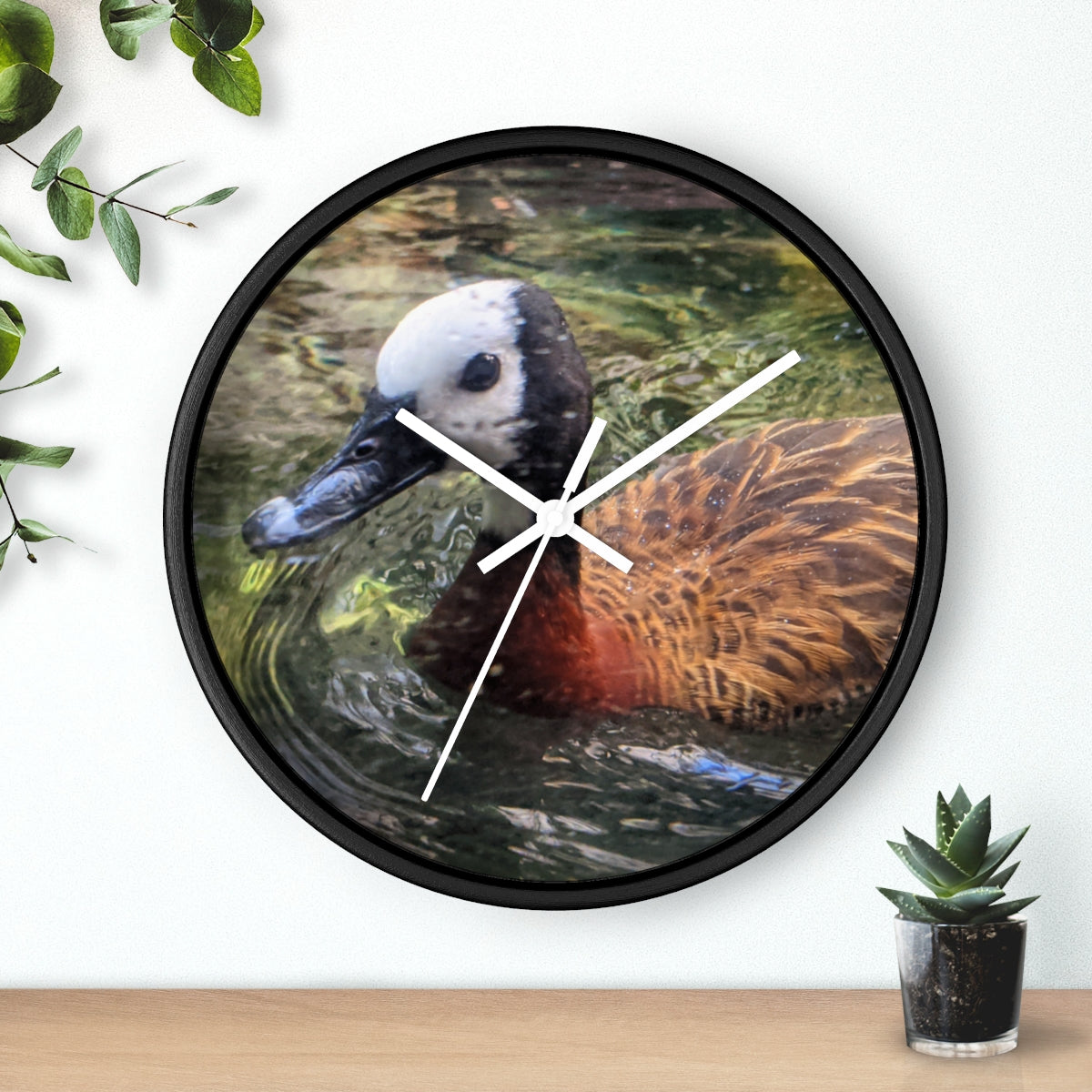 A charming Duck Wall Clock featuring a wooden frame and a plexiglass face, perfect for indoor decor.