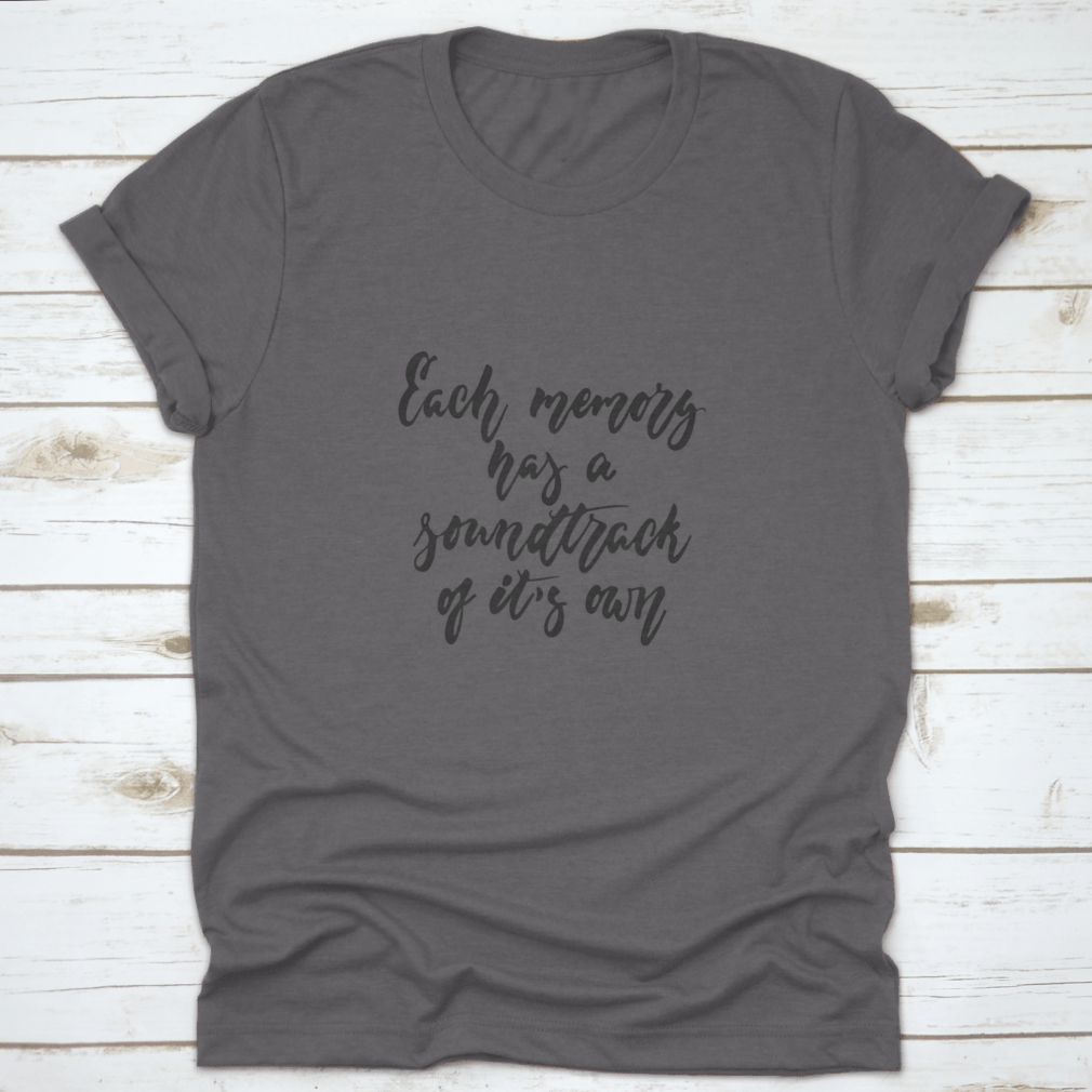 A stylish t-shirt featuring the phrase 'Each Memory Has A Soundtrack Of Its Own' in an inspirational design, made from soft cotton fabric.