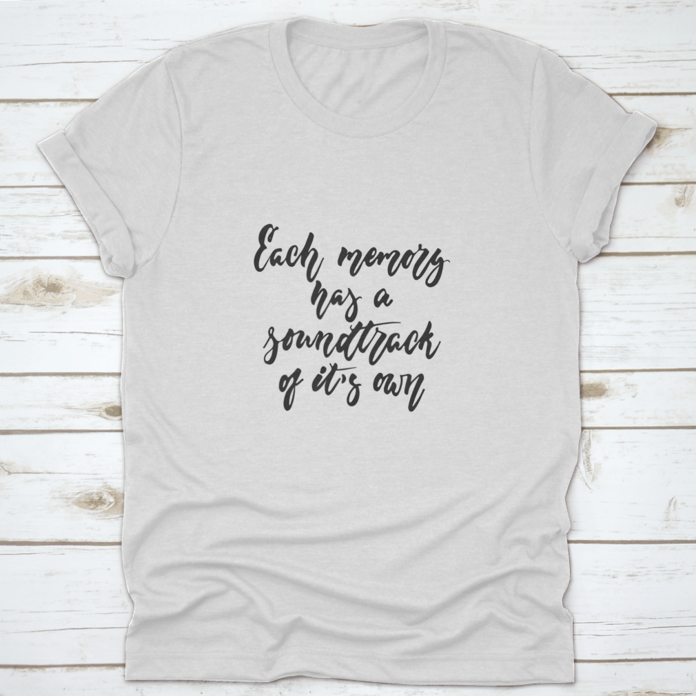 A stylish t-shirt featuring the phrase 'Each Memory Has A Soundtrack Of Its Own' in an inspirational design, made from soft cotton fabric.