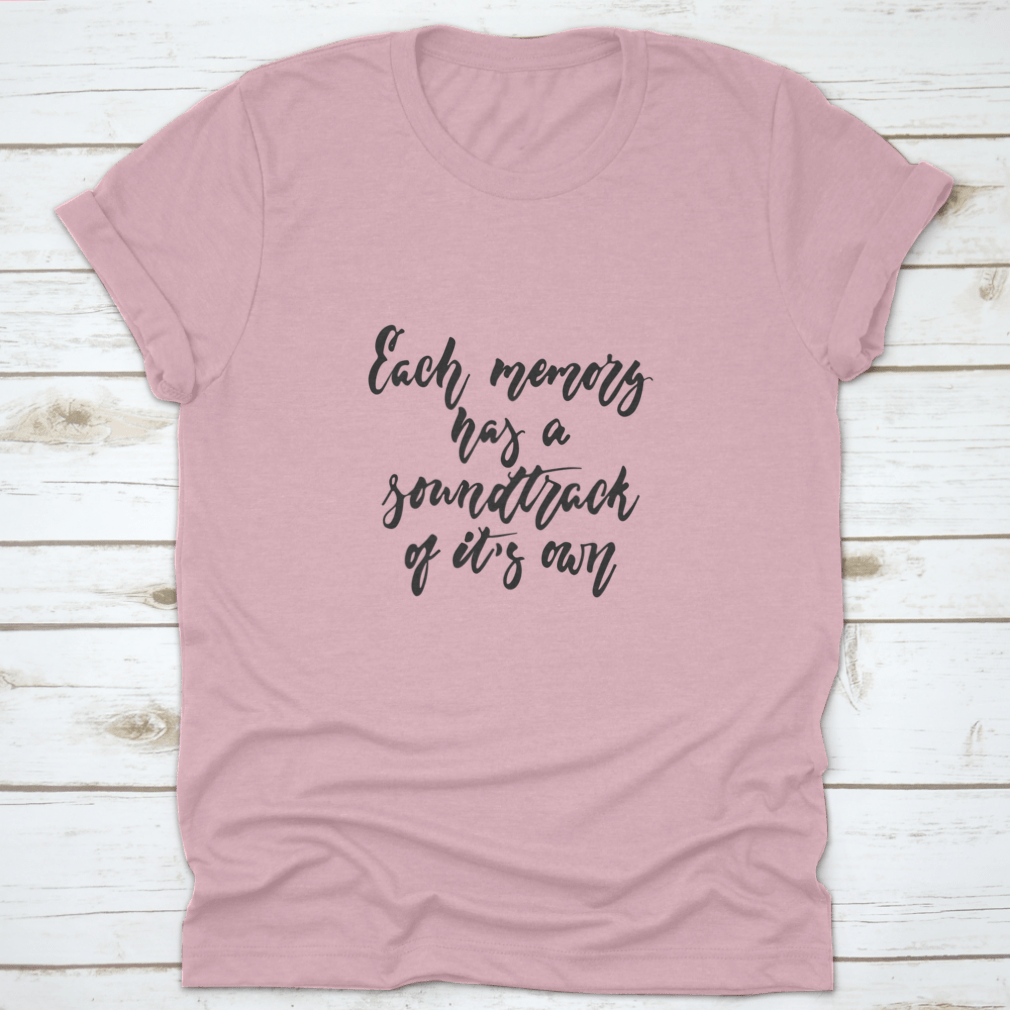 A stylish t-shirt featuring the phrase 'Each Memory Has A Soundtrack Of Its Own' in an inspirational design, made from soft cotton fabric.