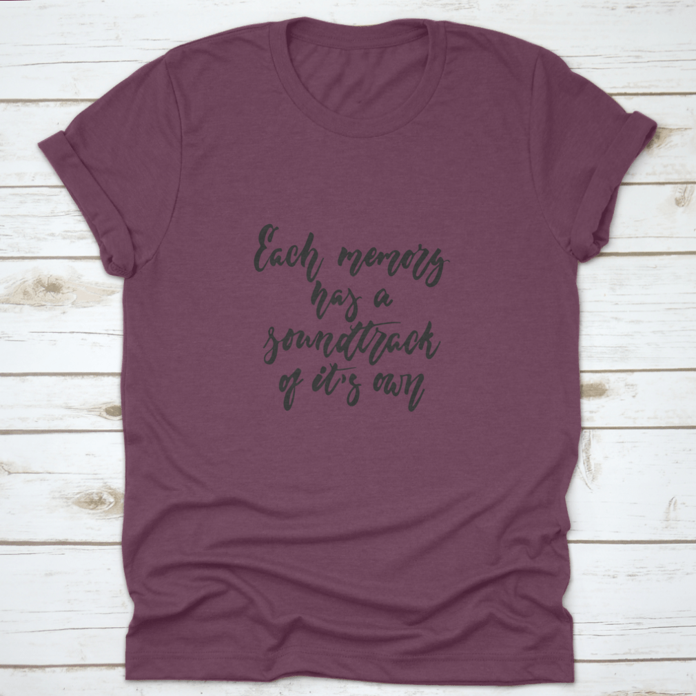 A stylish t-shirt featuring the phrase 'Each Memory Has A Soundtrack Of Its Own' in an inspirational design, made from soft cotton fabric.