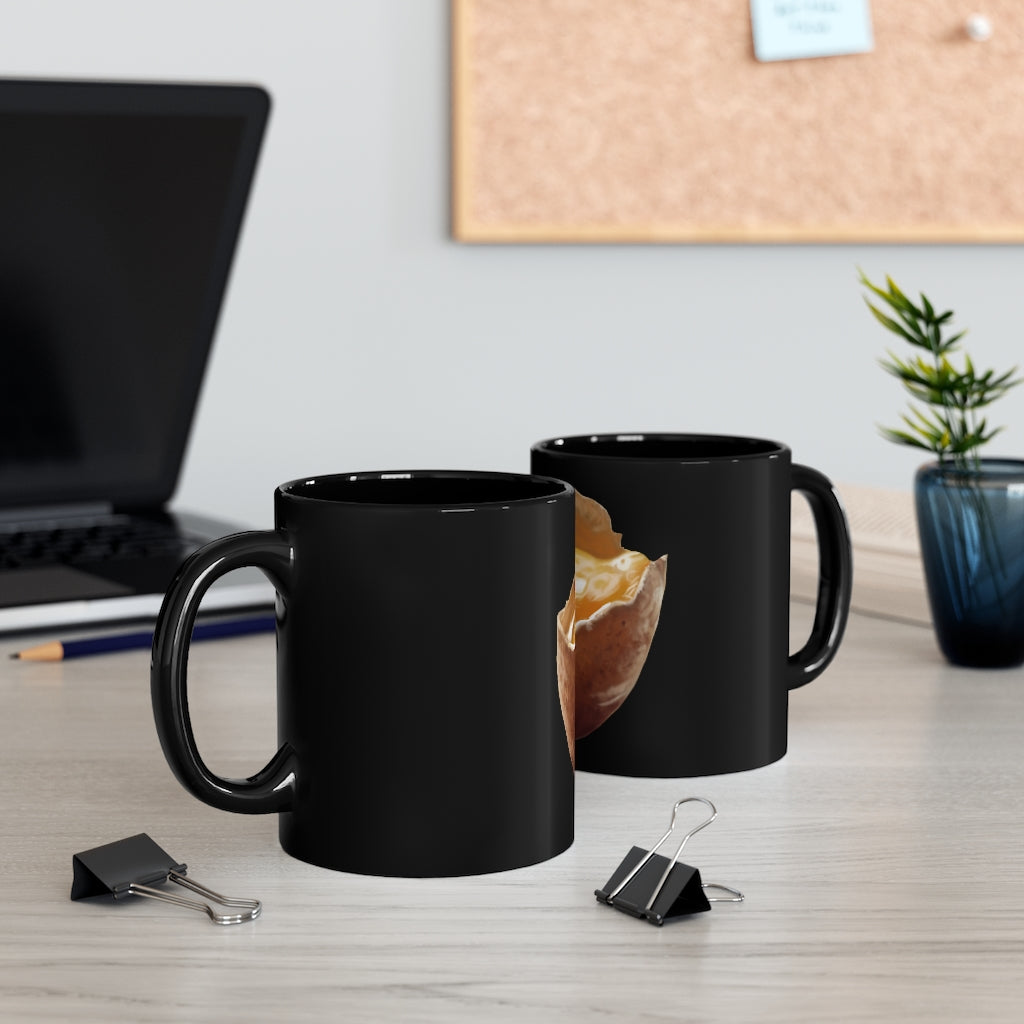 A sleek 11oz black ceramic mug with a C-handle, perfect for coffee, tea, or hot chocolate, showcasing a customizable design.