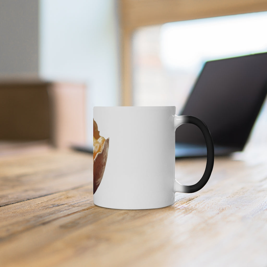 A white ceramic mug that changes color when filled with hot liquid, featuring a rounded design and C-handle.