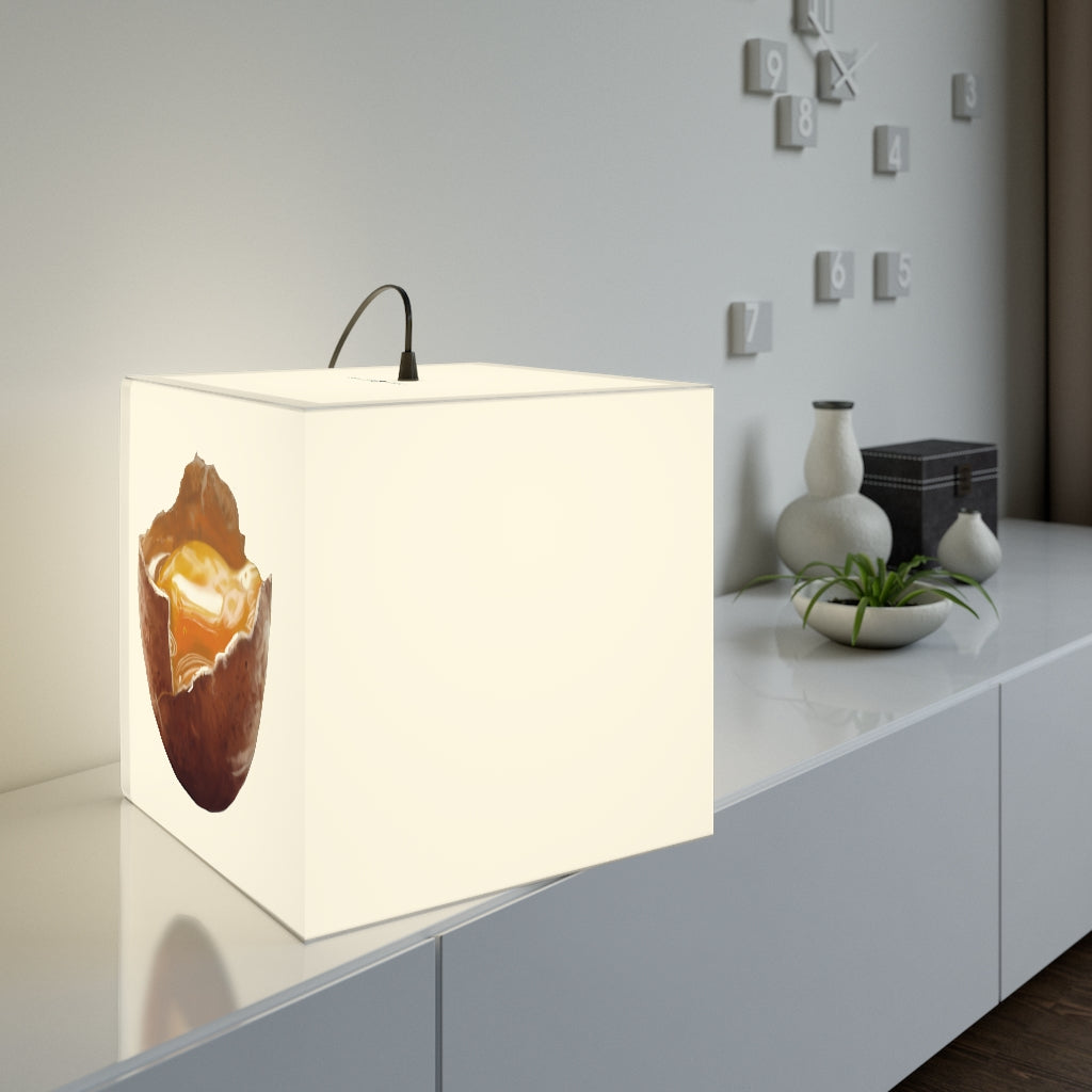 A stylish Egg Personalized Lamp in a modern setting, showcasing its unique cube design and soft glow.