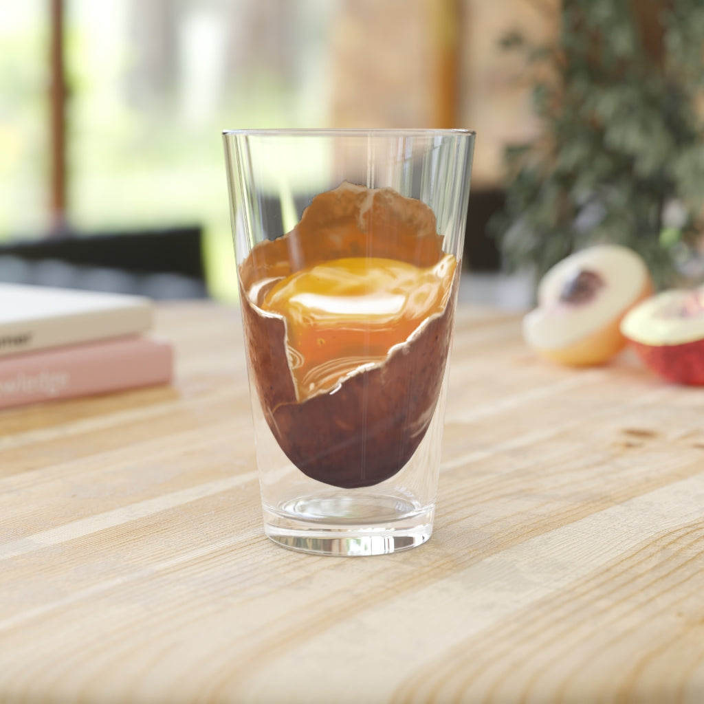 A clear 16oz Egg Pint Glass showcasing its elegant design, perfect for beverages and personalization.