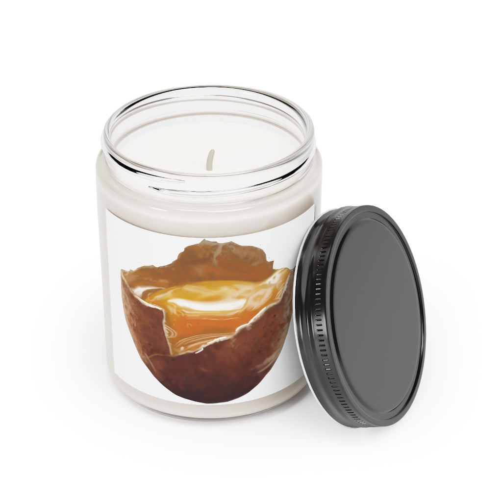 A beautifully hand-poured Egg Scented Candle in a glass container, featuring a permanent adhesive label, showcasing its vegan soy coconut wax.