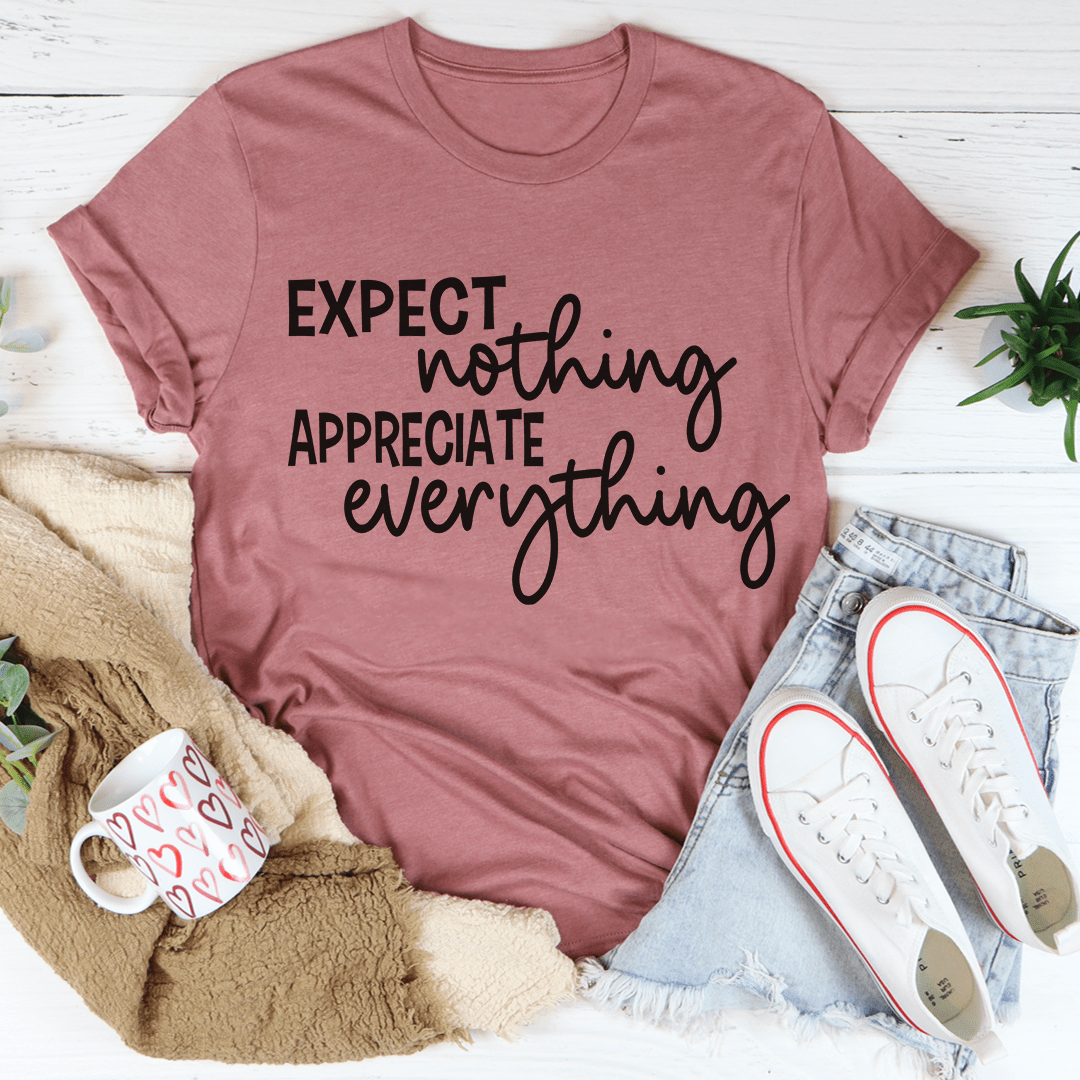 A soft, durable t-shirt featuring the phrase 'Expect Nothing Appreciate Everything' printed on it, showcasing its comfortable fit and quality stitching.