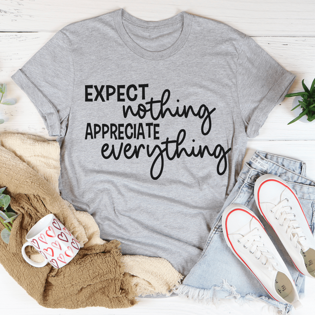 A soft, durable t-shirt featuring the phrase 'Expect Nothing Appreciate Everything' printed on it, showcasing its comfortable fit and quality stitching.