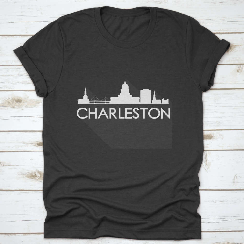 White t-shirt featuring a flat icon skyline silhouette of famous buildings in Charleston, showcasing a stylish design.