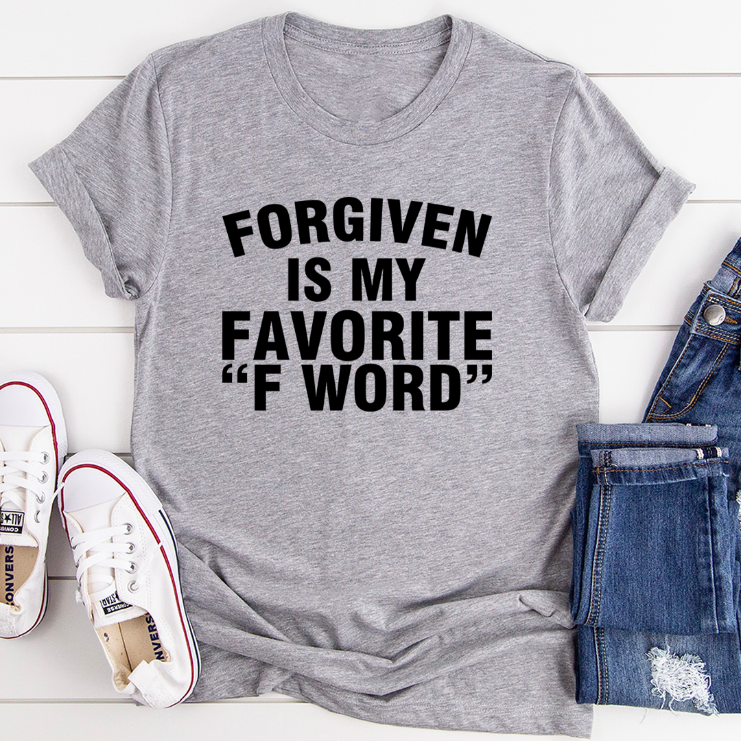 A stylish black t-shirt featuring the phrase 'Forgiven Is My Favorite F Word' printed in bold letters, showcasing its soft fabric and durable stitching.