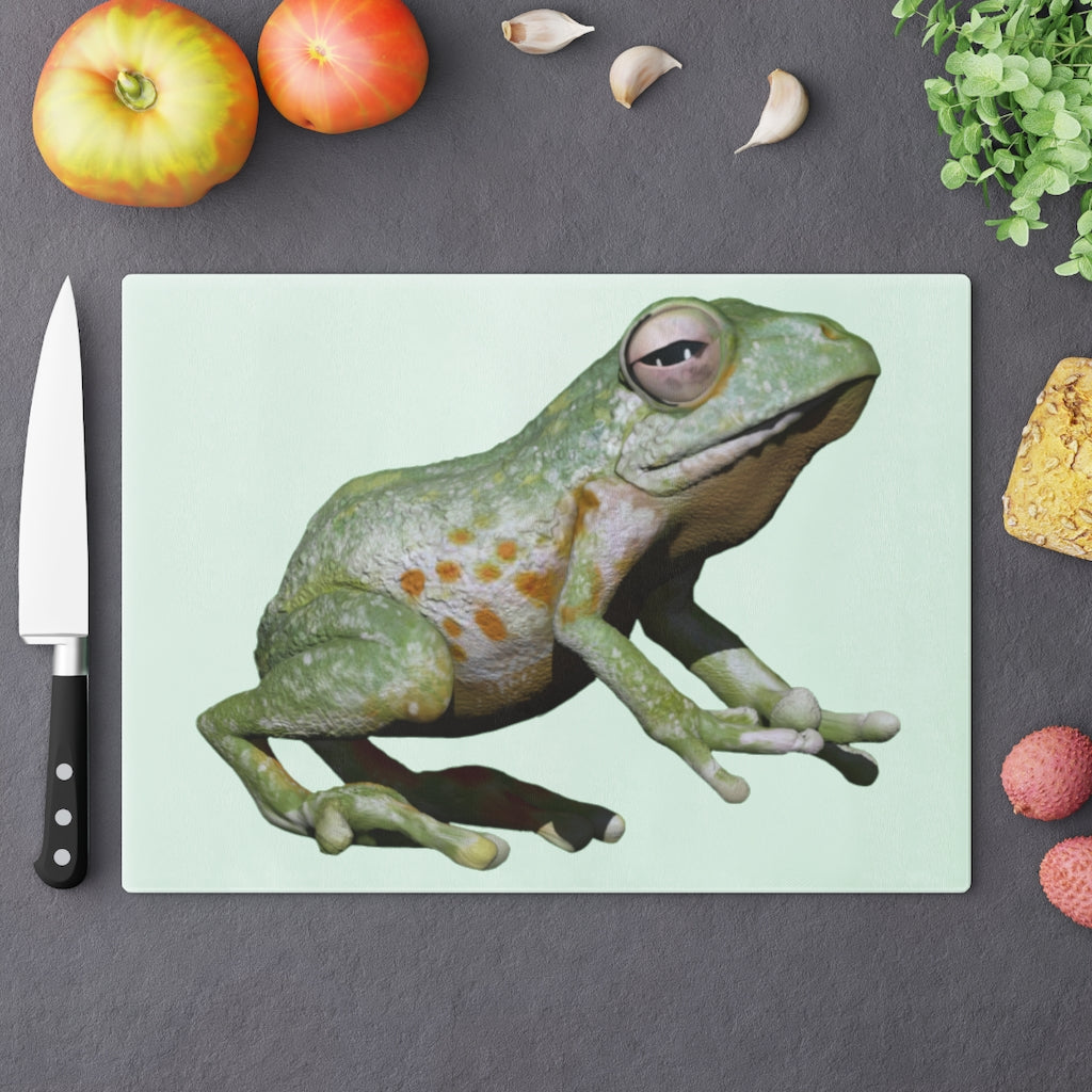 A vibrant frog-themed tempered glass cutting board with rubber dots for stability, perfect for kitchen use.