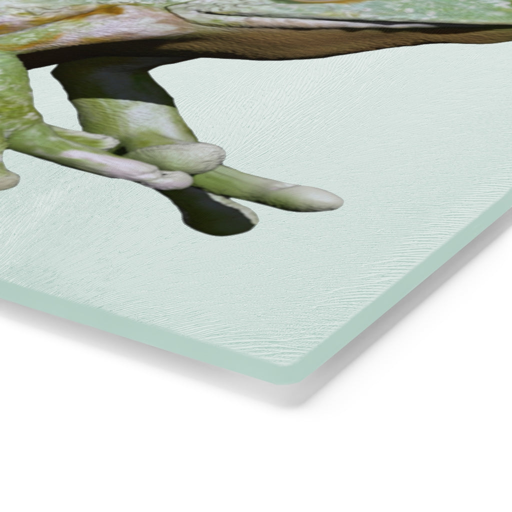 A vibrant frog-themed tempered glass cutting board with rubber dots for stability, perfect for kitchen use.