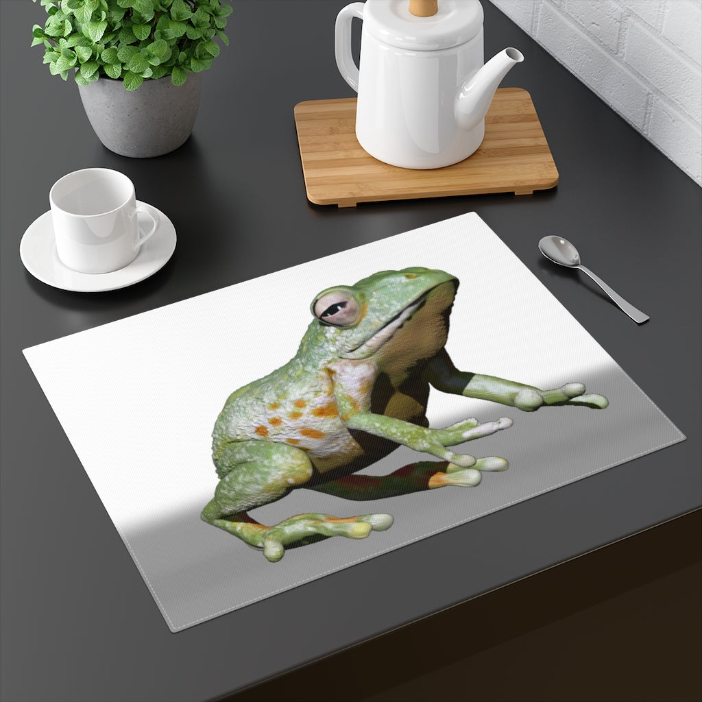 A vibrant frog-themed placemat made of durable cotton, featuring a playful design on one side and a natural back.