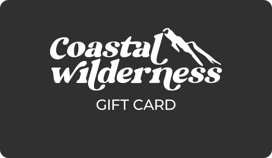 Coastal Wilderness gift card displayed on a rustic wooden background, featuring a scenic outdoor design.