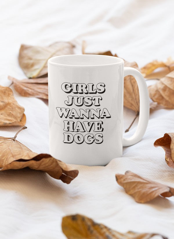 A stylish 11oz ceramic mug with a glossy finish featuring the phrase 'Girls Just Wanna Have Dogs', perfect for dog lovers.