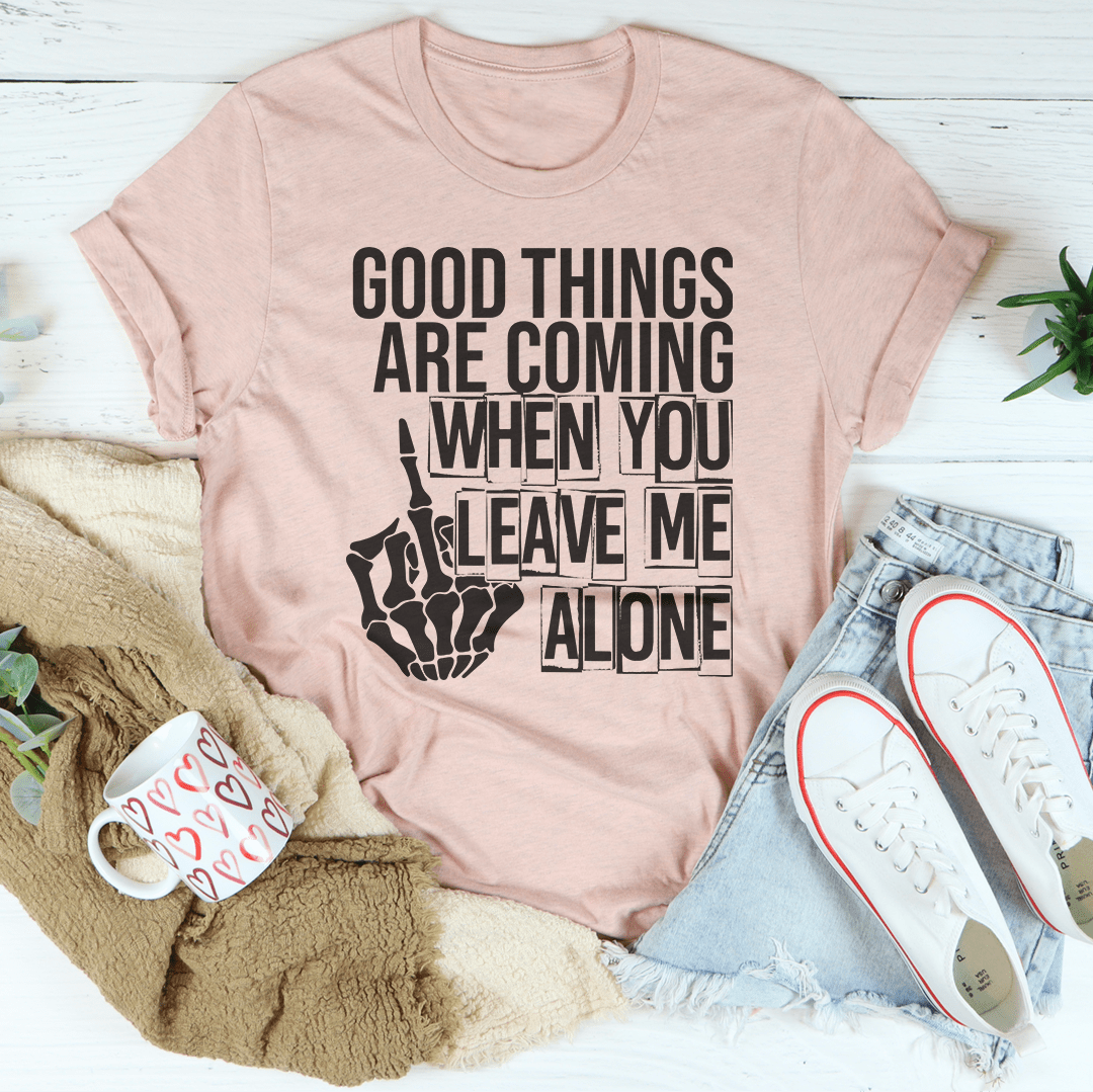 A stylish black t-shirt featuring the phrase 'Good Things Are Coming When You Leave Me Alone' in bold print, showcasing its soft fabric and durable stitching.