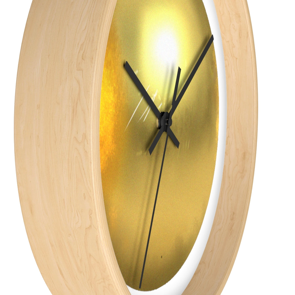 Elegant gold wall clock with wooden frame and plexiglass face, perfect for indoor decor.