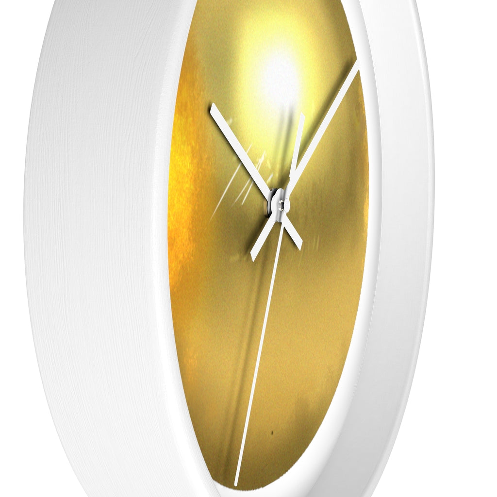 Elegant gold wall clock with wooden frame and plexiglass face, perfect for indoor decor.