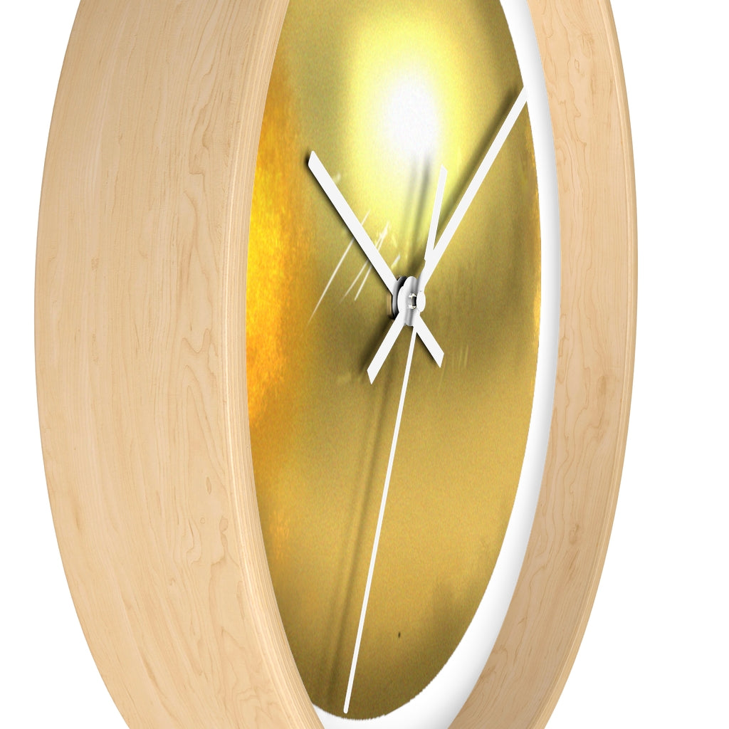 Elegant gold wall clock with wooden frame and plexiglass face, perfect for indoor decor.