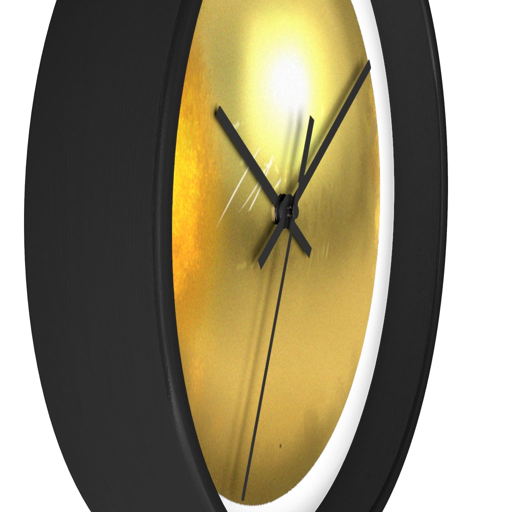 Elegant gold wall clock with wooden frame and plexiglass face, perfect for indoor decor.