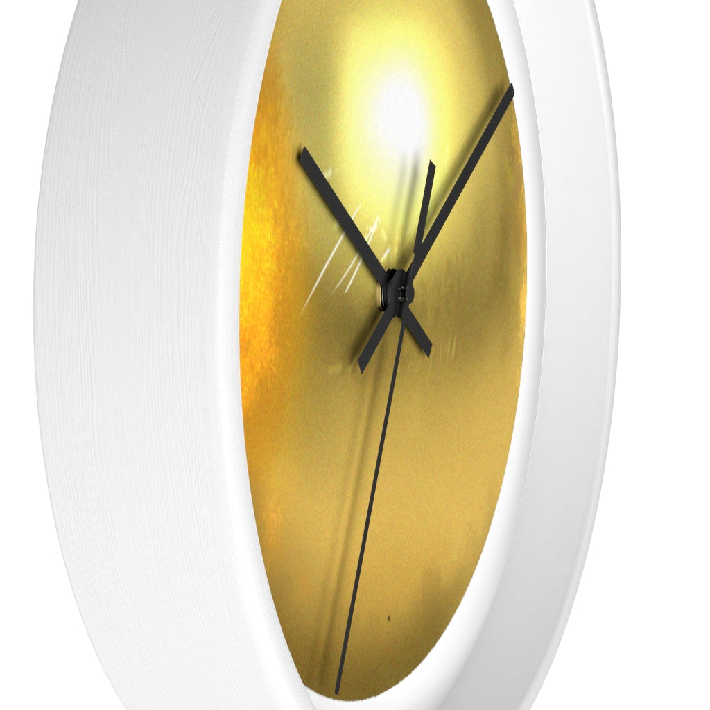 Elegant gold wall clock with wooden frame and plexiglass face, perfect for indoor decor.