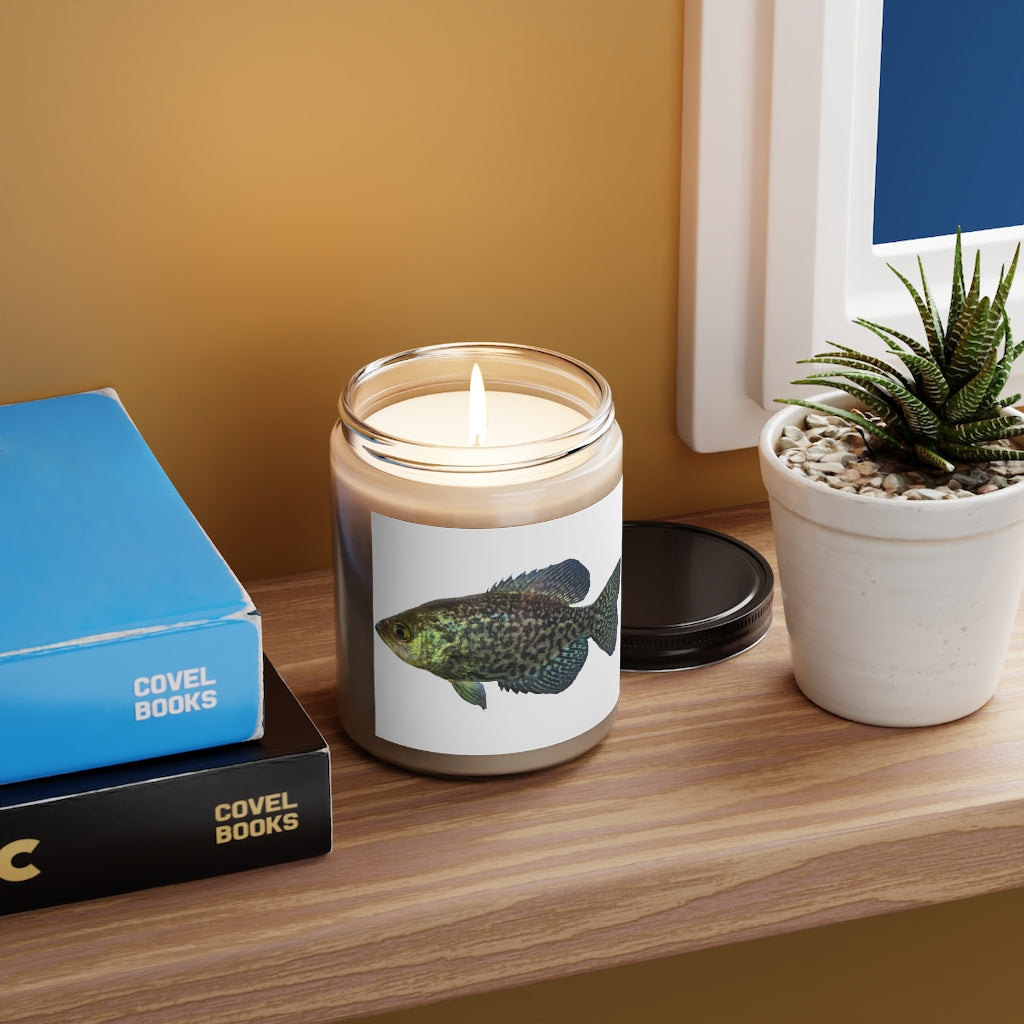 Golden Fish Scented Candle in a glass container, featuring a warm glow and a stylish label, showcasing its vegan soy coconut wax composition.