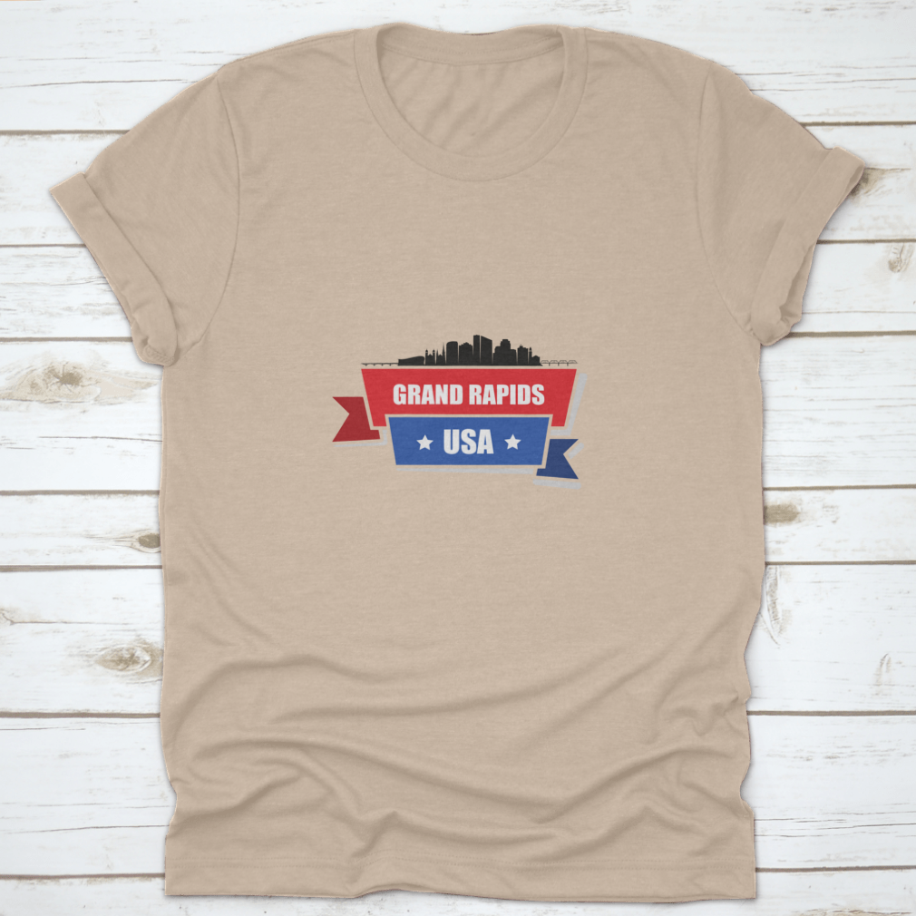 A stylish t-shirt featuring the Grand Rapids skyline design with red and blue ribbons, made from 100% cotton.