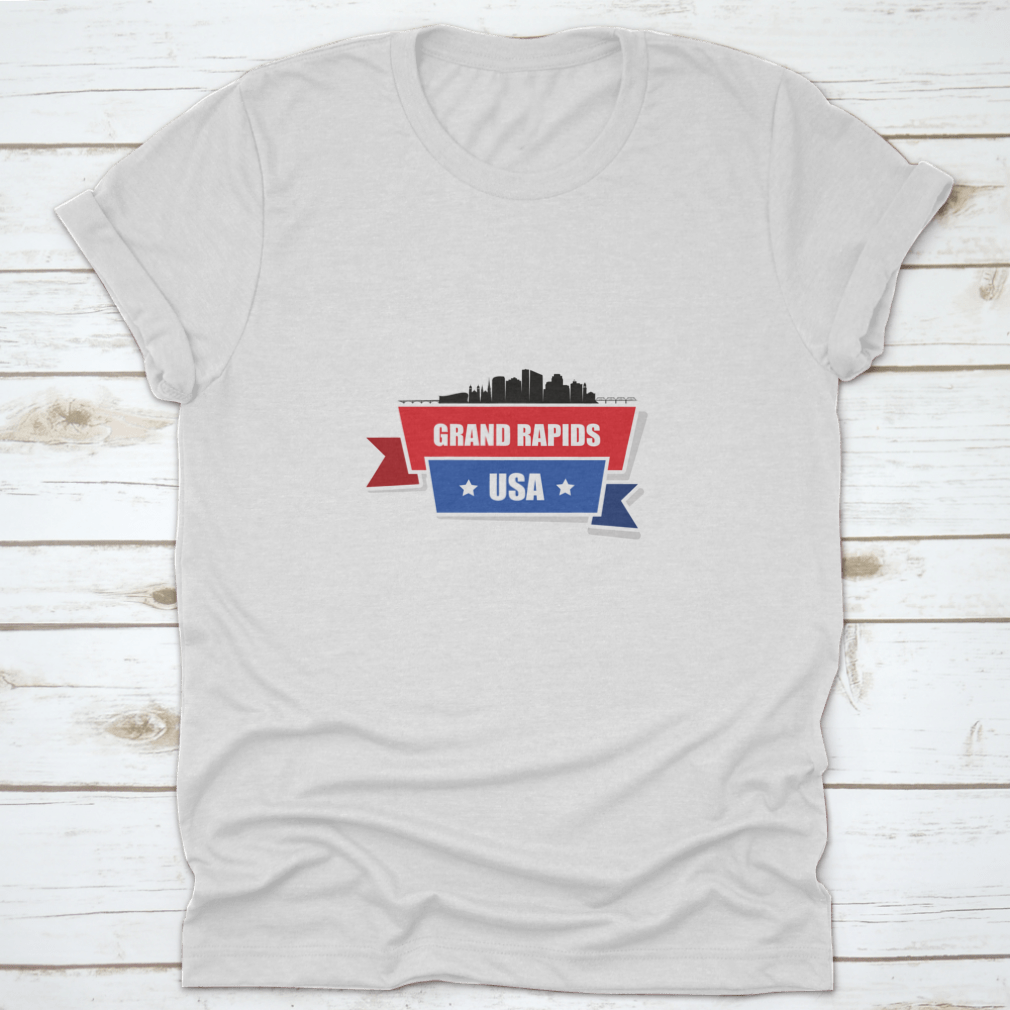 A stylish t-shirt featuring the Grand Rapids skyline design with red and blue ribbons, made from 100% cotton.