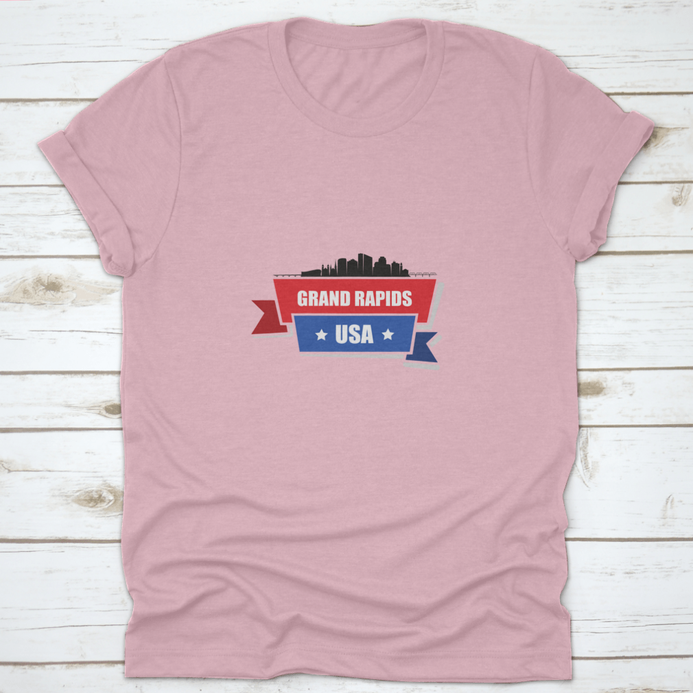 A stylish t-shirt featuring the Grand Rapids skyline design with red and blue ribbons, made from 100% cotton.