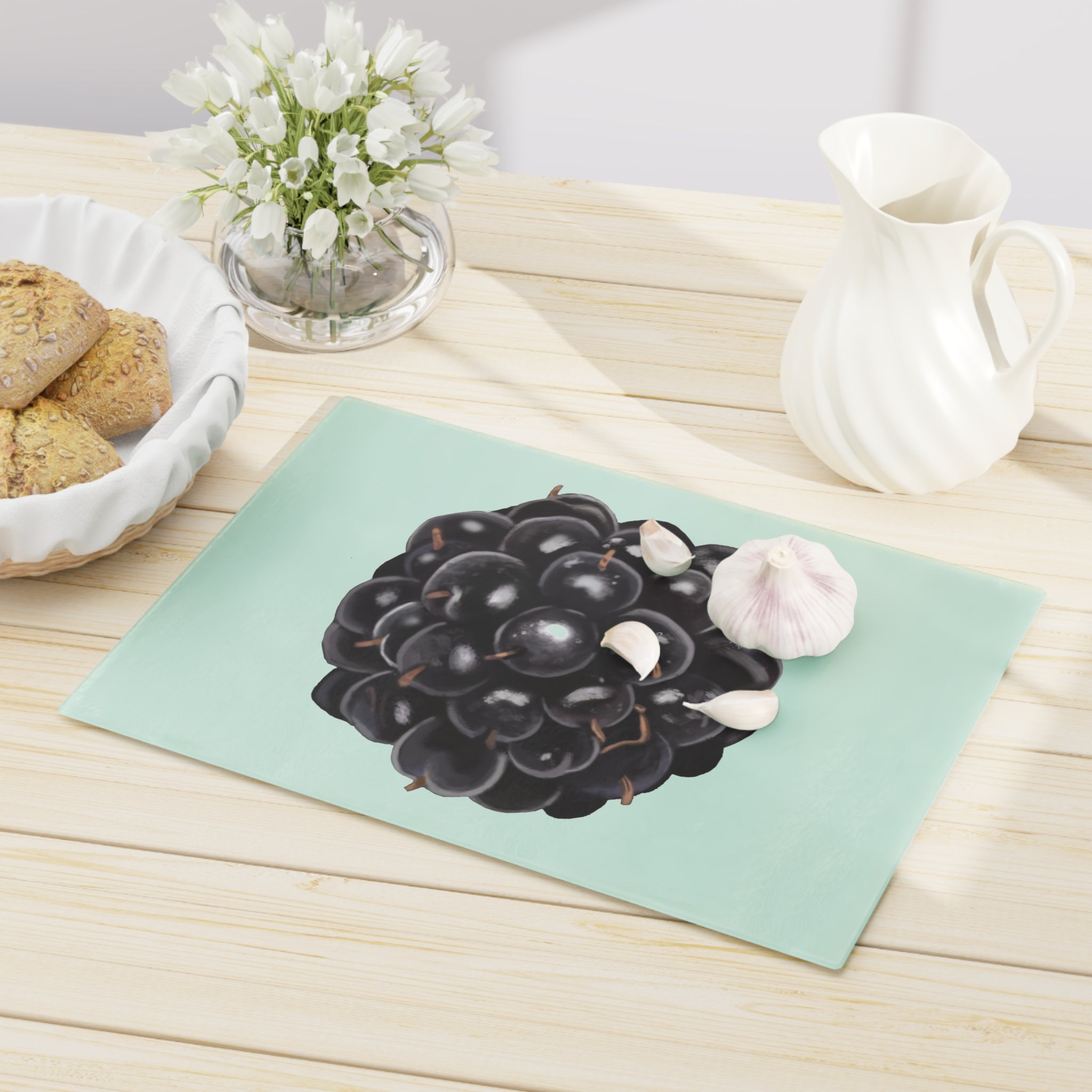 A stylish Grape Cutting Board made of tempered glass with a grape design, featuring four rubber dots for stability.