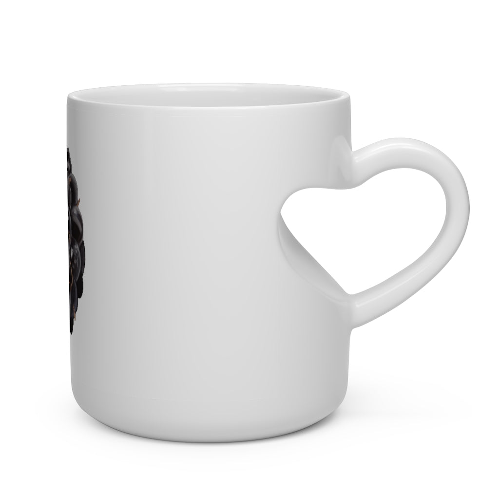 A white ceramic mug shaped like a heart with a heart-shaped handle, perfect for hot beverages.