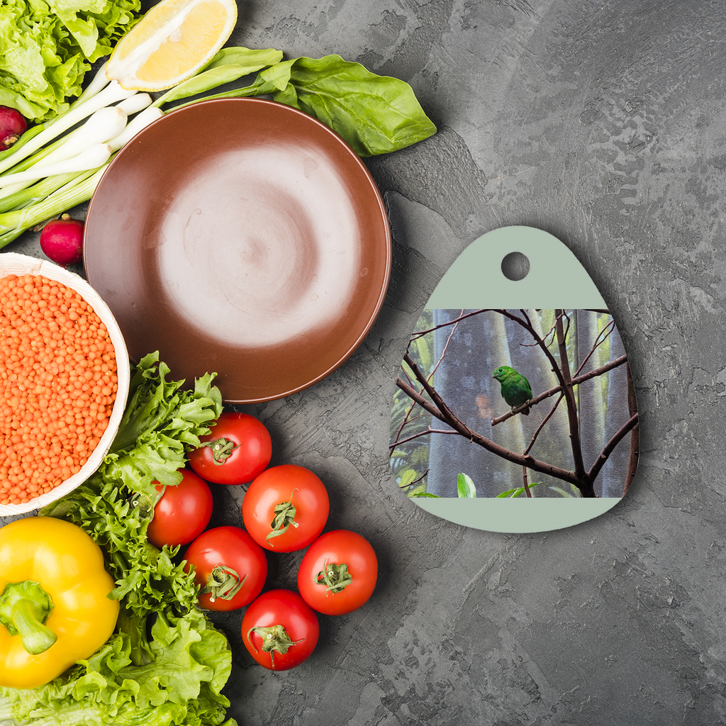 Green Bird Sublimation Glass Cutting Board with a water droplet shape, featuring a smooth surface for custom designs and four rubber feet for stability.