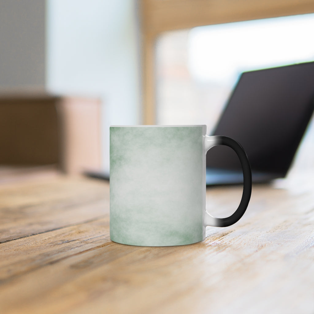 Green Clouds Color Changing Mug showcasing vibrant colors when filled with hot liquid, featuring a C-handle and rounded corners.