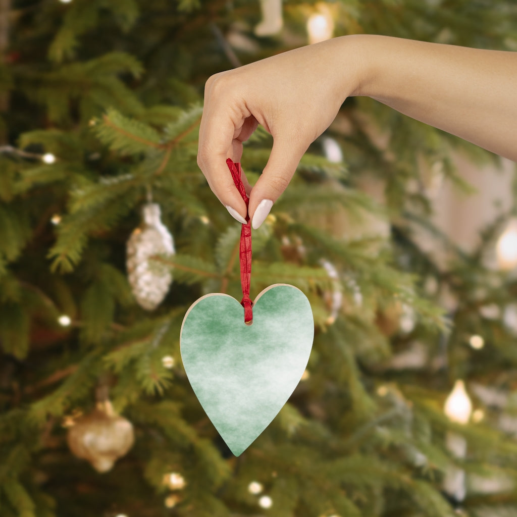 A collection of Green Clouds Wooden Christmas Ornaments in various whimsical shapes, featuring a rustic wood finish and red ribbons for hanging.