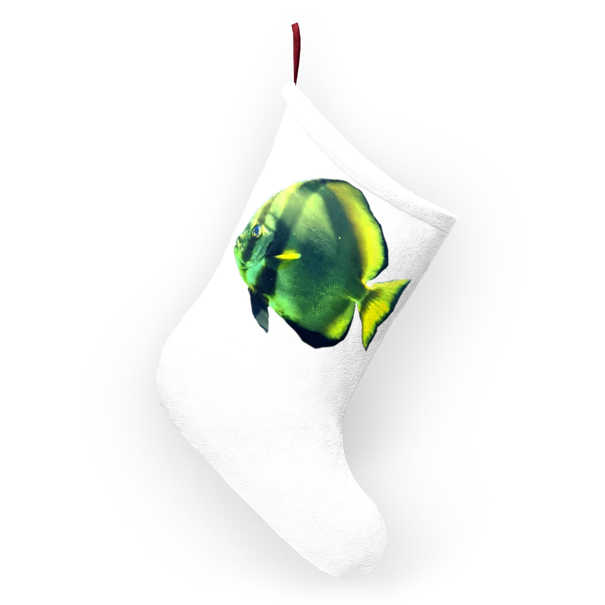 A cozy green fish Christmas stocking hanging by a fireplace, featuring custom prints and a twill ribbon loop.