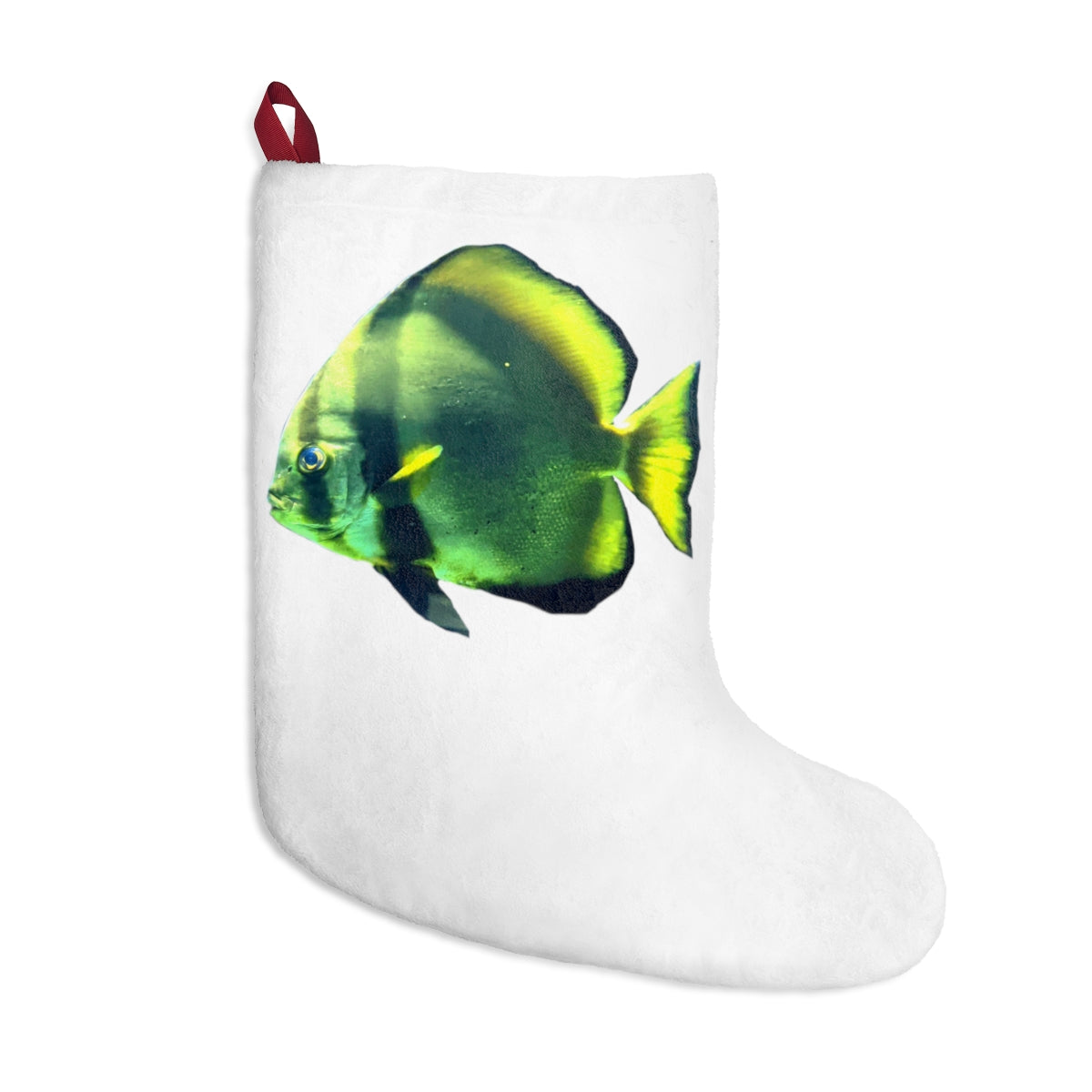 A cozy green fish Christmas stocking hanging by a fireplace, featuring custom prints and a twill ribbon loop.