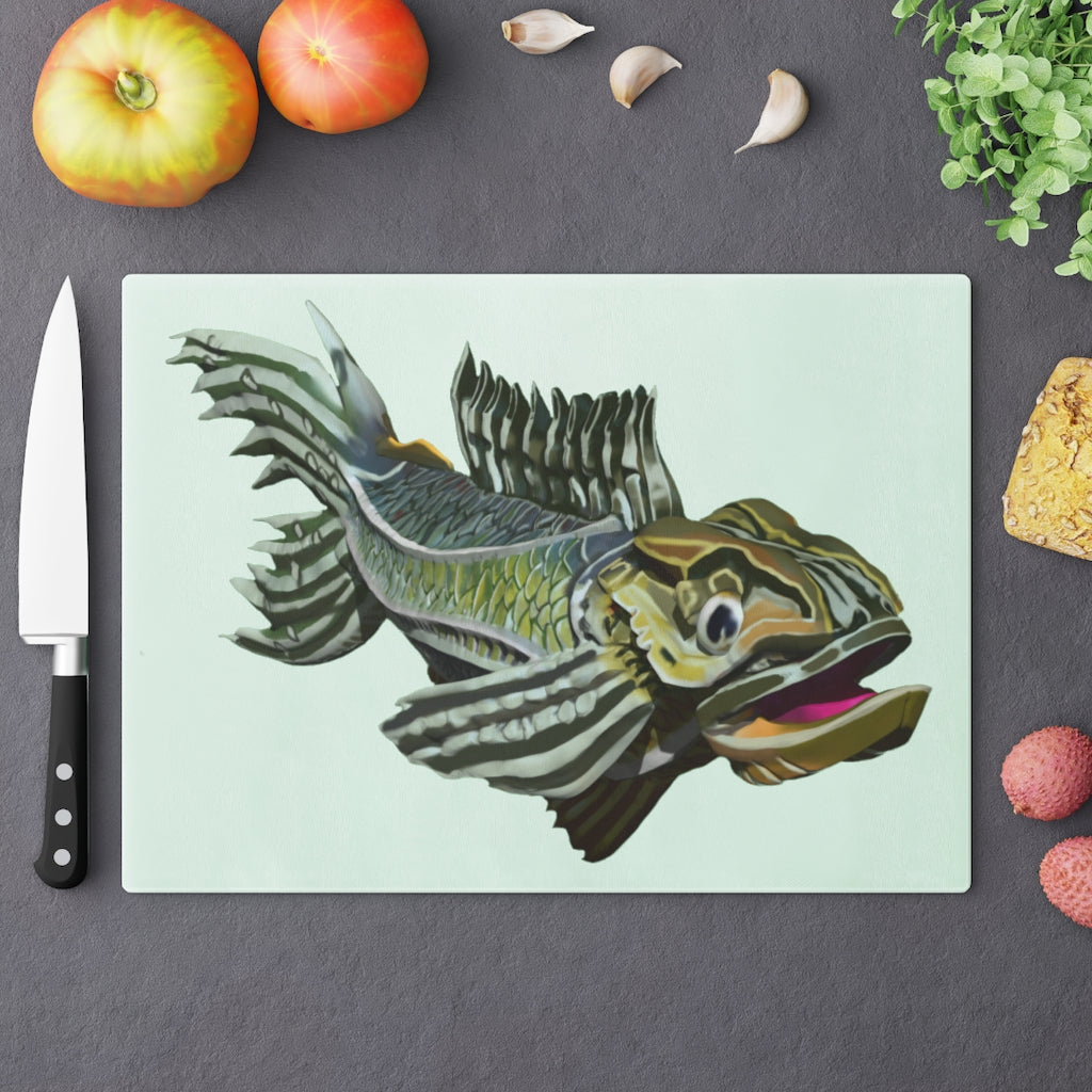 A stylish green fish cutting board made of tempered glass, featuring a unique fish design and four rubber dots for stability.