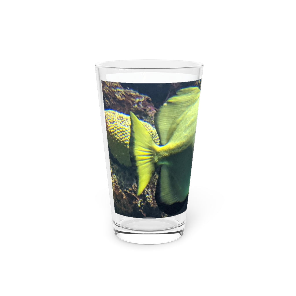 A clear 16oz pint glass featuring a green fish design, perfect for personalized beverages.