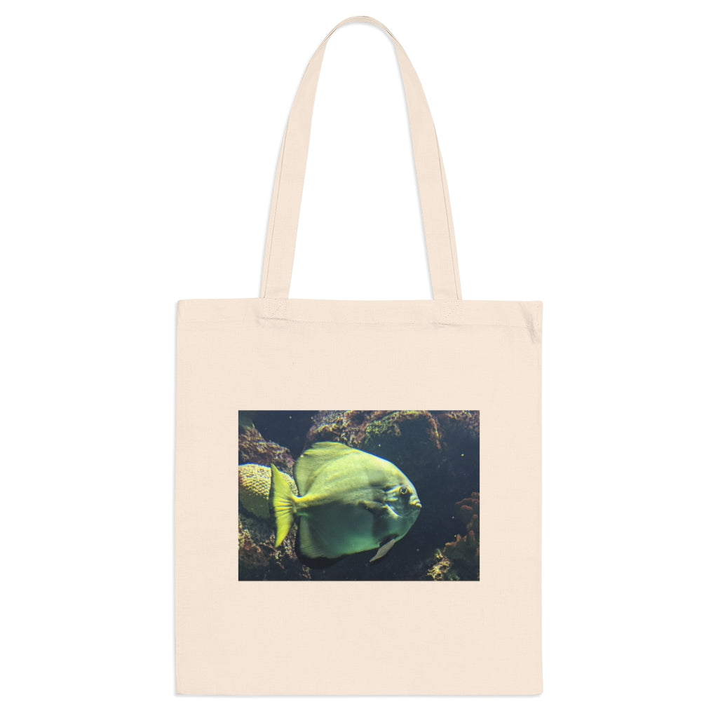 A vibrant Green Fish Tote Bag made of 100% cotton, featuring long cross-stitched handles for added stability.