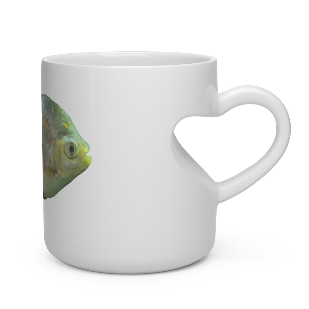 A white ceramic heart-shaped mug with a green fish design and a heart-shaped handle, perfect for hot beverages.