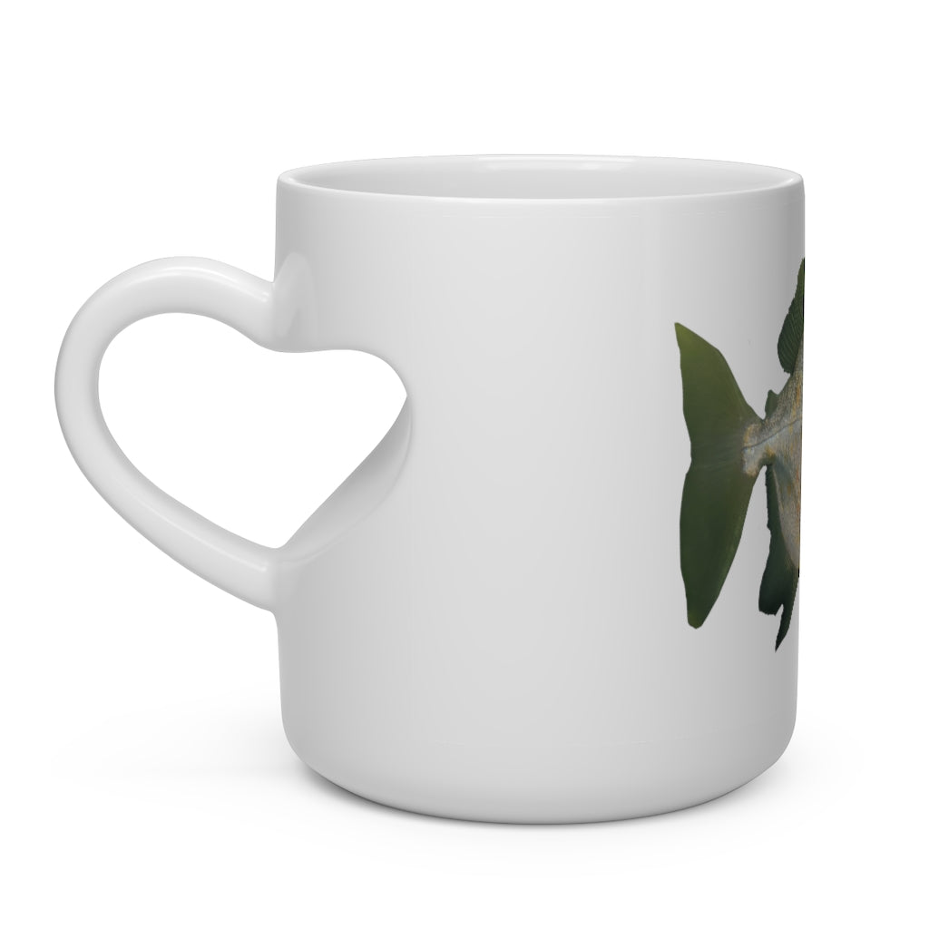 A white ceramic heart-shaped mug with a green fish design and a heart-shaped handle, perfect for hot beverages.