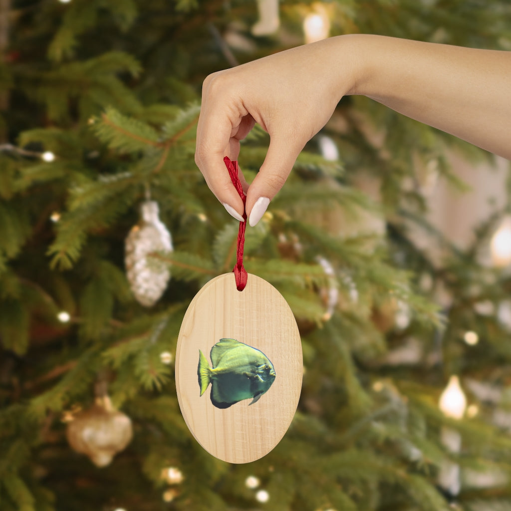 A collection of Green Fish Wooden Christmas Ornaments in various whimsical shapes, featuring a rustic wood finish and red ribbons for hanging.