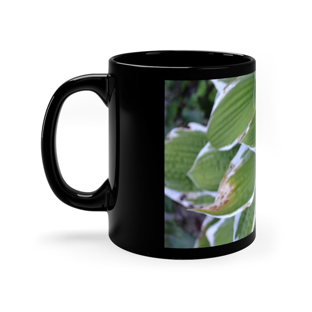 Green Leaves 11oz black ceramic mug with a C-handle, perfect for coffee, tea, or hot chocolate.