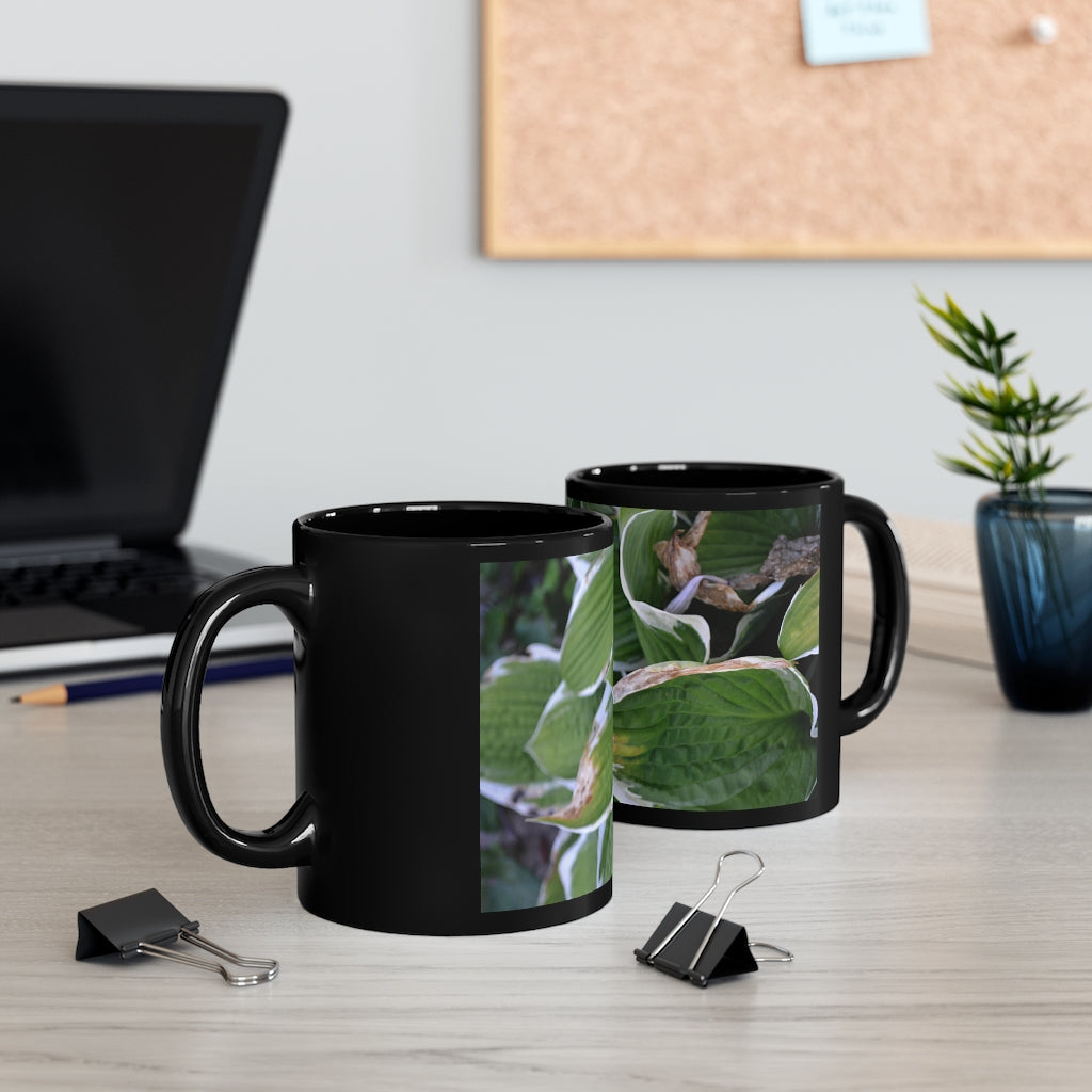 Green Leaves 11oz black ceramic mug with a C-handle, perfect for coffee, tea, or hot chocolate.