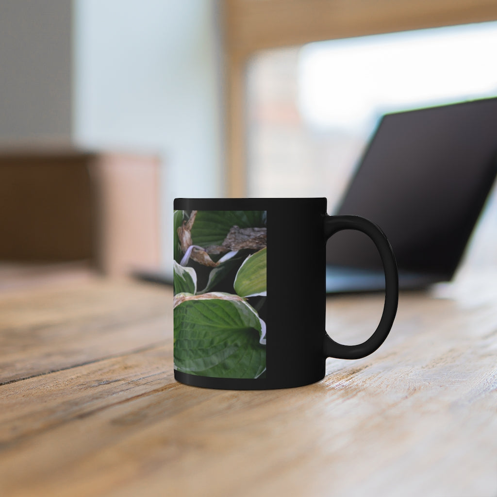 Green Leaves 11oz black ceramic mug with a C-handle, perfect for coffee, tea, or hot chocolate.