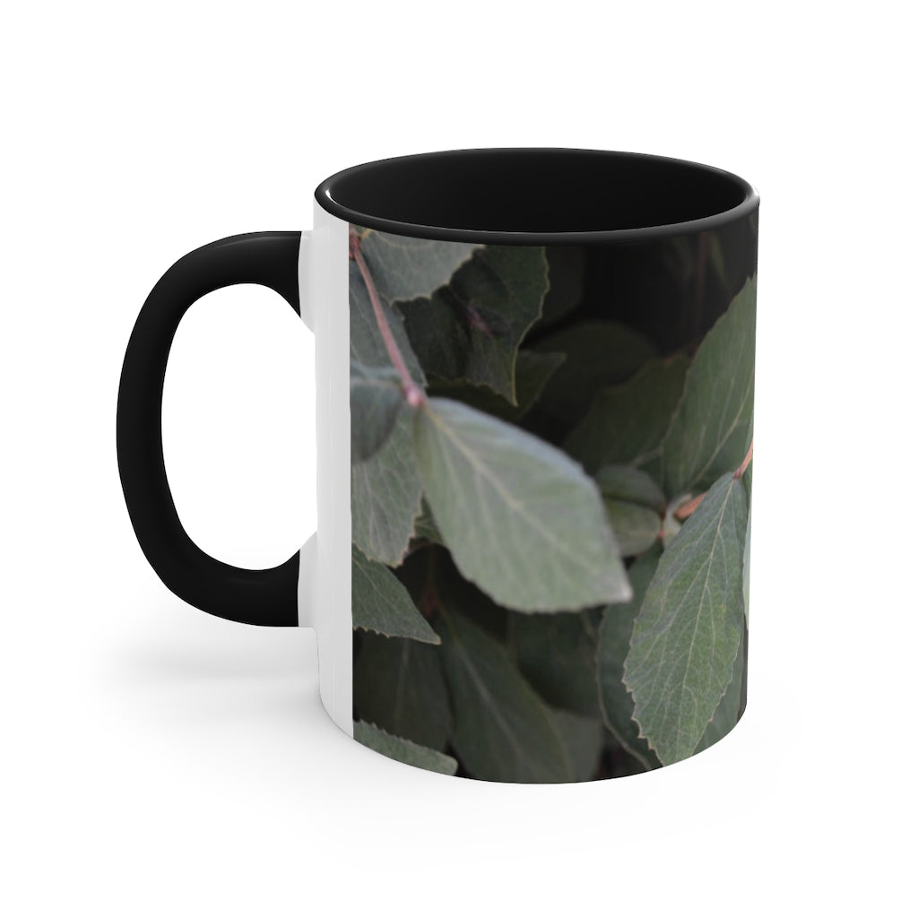 A stylish Green Leaves Accent Mug featuring a white exterior with a colored interior, showcasing a beautiful green leaves design.