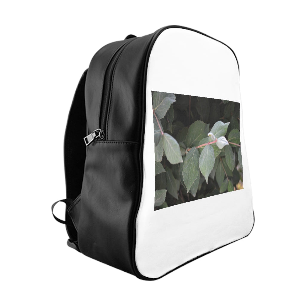 Green Leaves School Backpack featuring a vibrant green leaves print, padded back, and multiple inside pockets for organization.